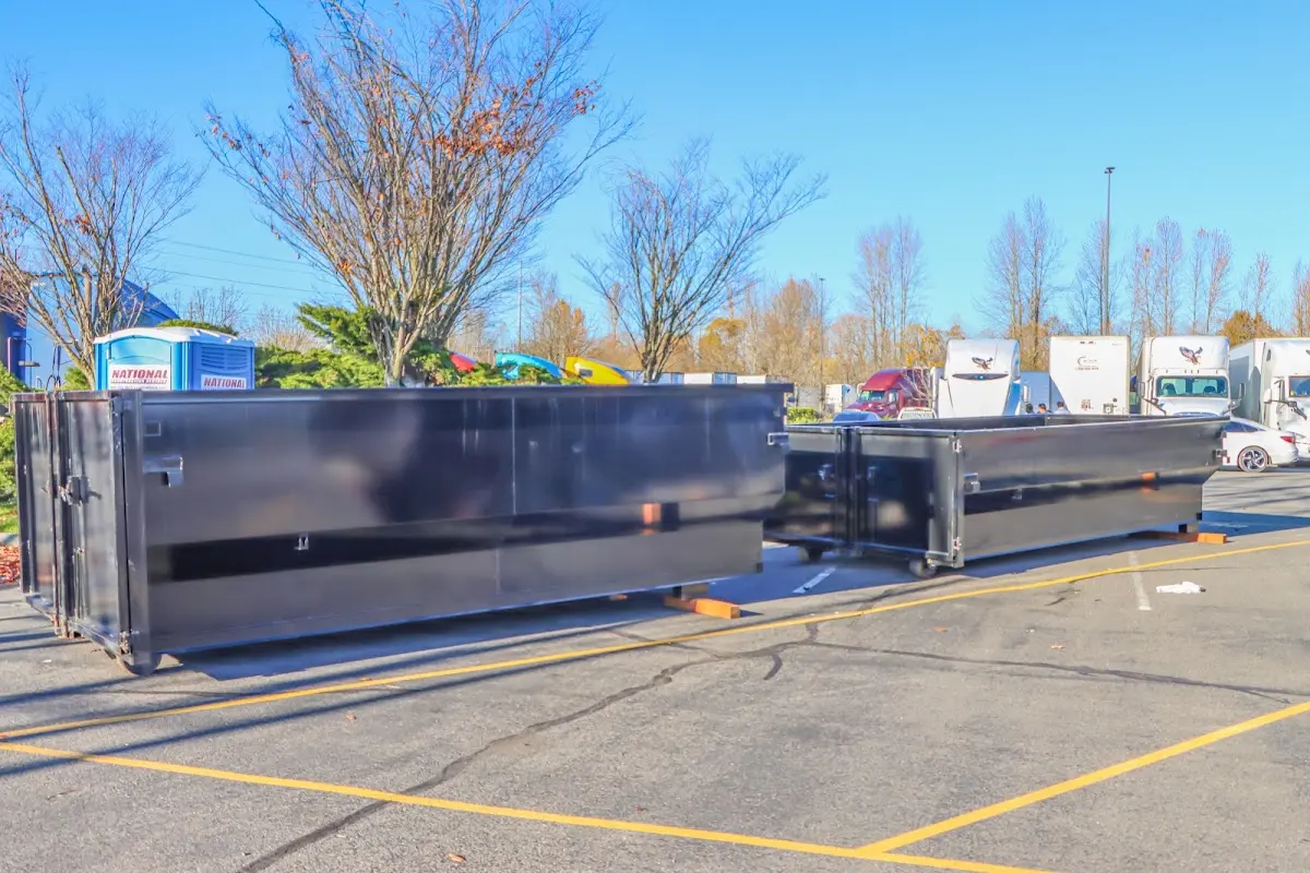 Professional dumpster rental service with roll-off container on residential driveway in Farmville